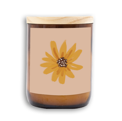 The Commonfolk scented mid-sized candle features a floral design, predominantly yellow, on a beige background, with a wooden lid.