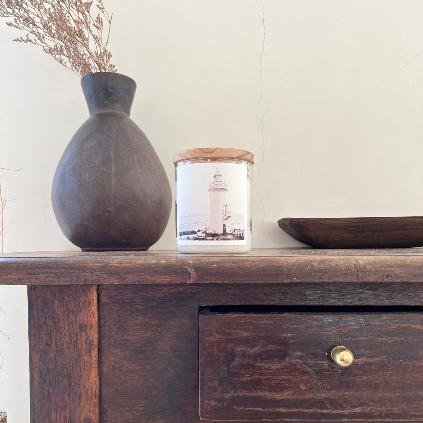 Dark wooden cabinet with a vase and decorative item on a light background