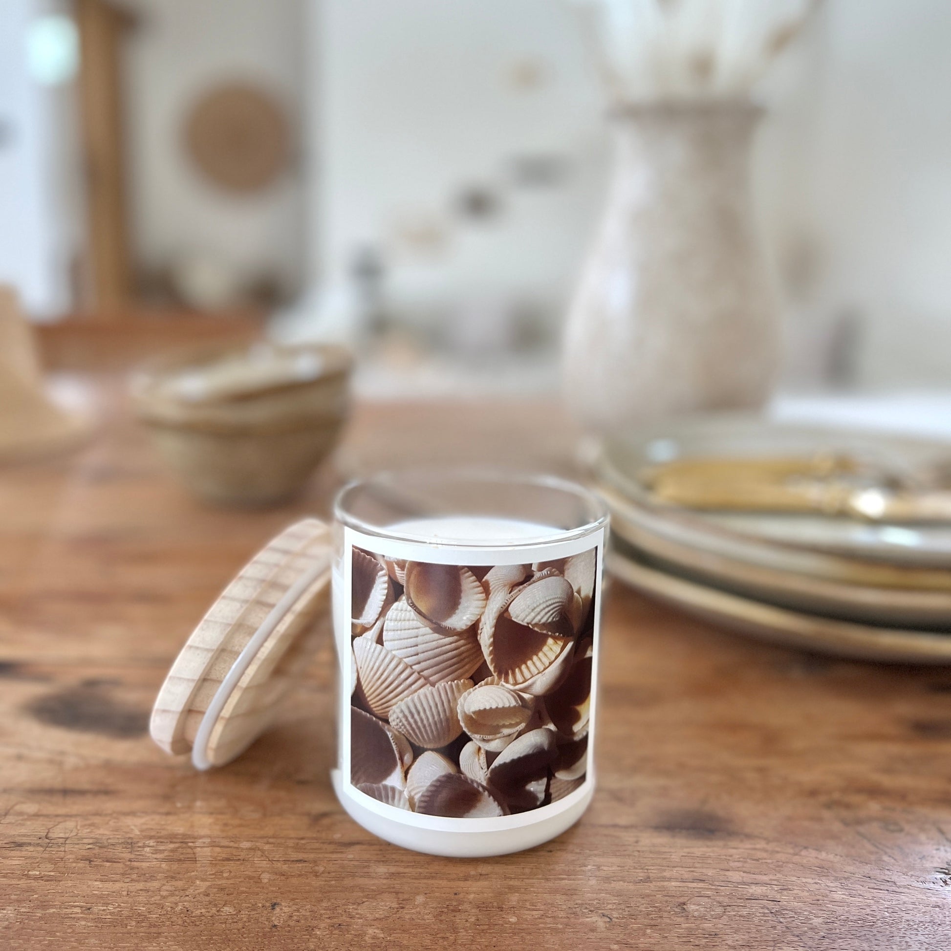 Candle with shell design on a wooden table