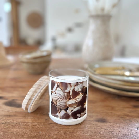 Candle with shell design on a wooden table