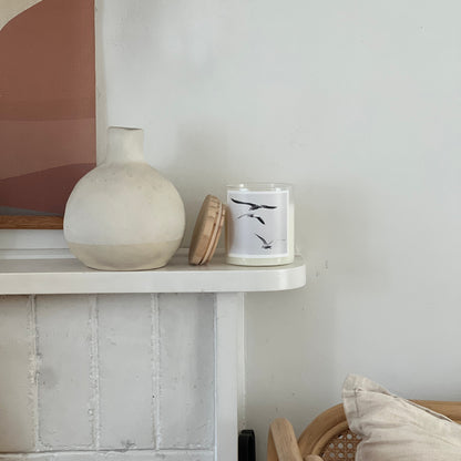 candle on fire place white walls vase 
