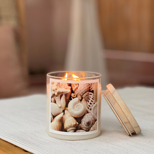 Candle in a jar with shell design on a table