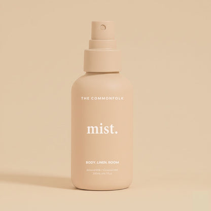 Nude mist spray bottle labeled 'mist' by 'The Commonfolk' on a beige background