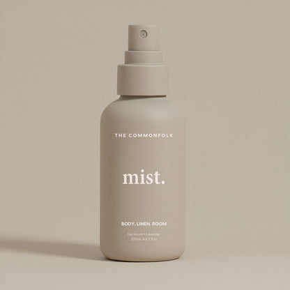 Mist spray bottle labeled 'The Commonfolk' on a beige background