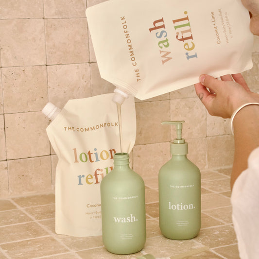 Refillable bottles and containers with 'The Commonfolk' branding on a tiled surface.