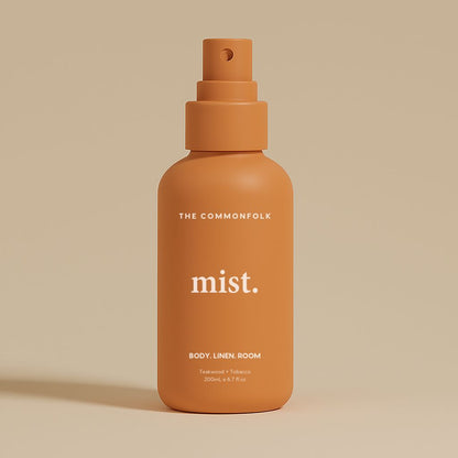 Terracotta spray bottle labeled 'mist' by 'The Commonfolk' on a beige background