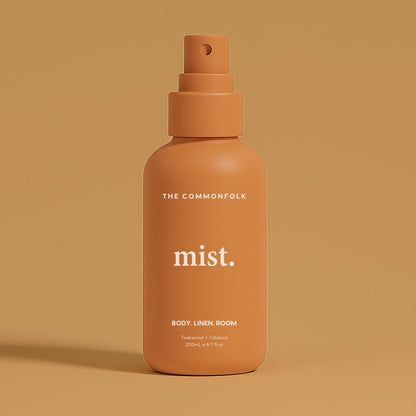 Terracotta bottle labeled 'mist.' by The Commonfolk on a matching brown background