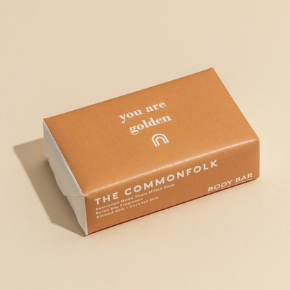 The Commonfolk 200g body bar soap packaging features the text 'you are golden' on the top of the brown wrapper.