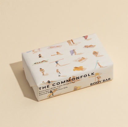 The Commonfolk 200g body bar soap, with illustrations of people in a beach setting on the wrapping.