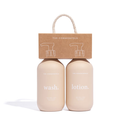The Commonfolk two matte finish 500ml bottles labeled 'wash' and 'lotion', respectively, with a recycled Kraft carry caddy packaging above them, all in a nude color.